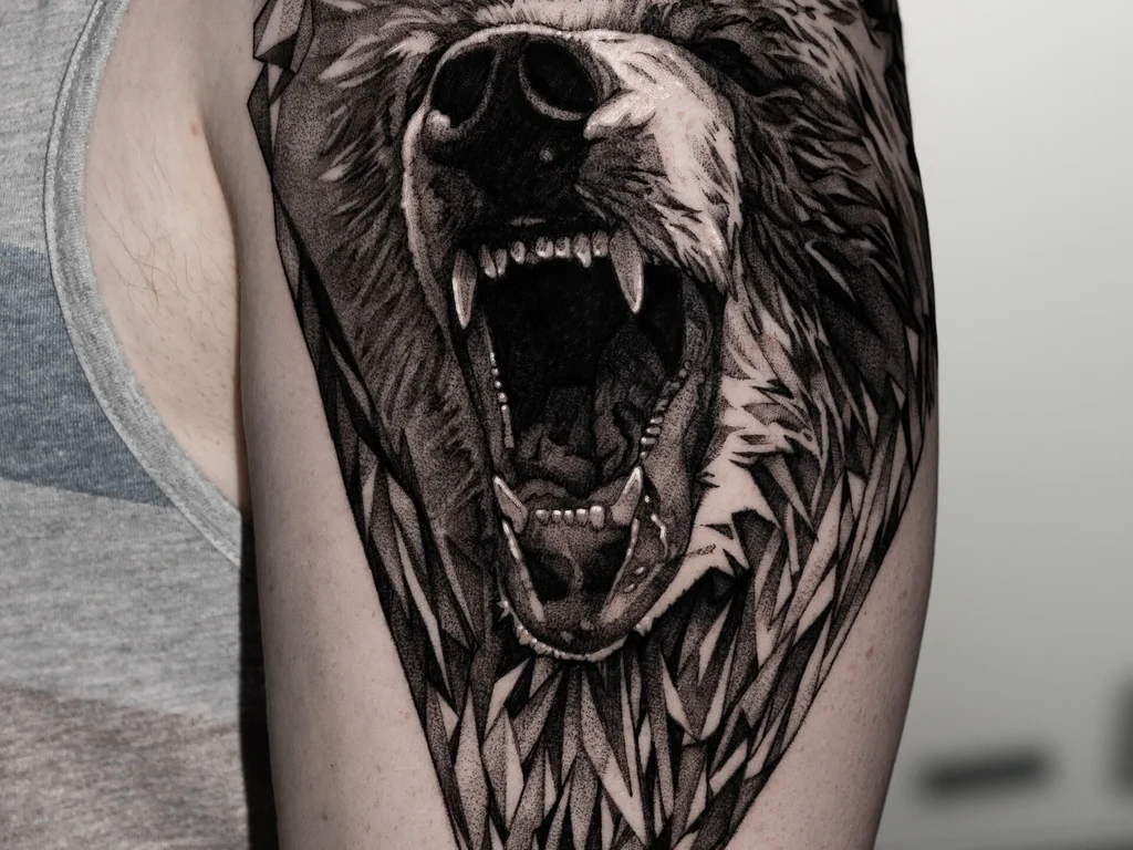 50 Animal Tattoo Ideas: The Complete Guide by Animal, Style and Placement 13 Black and grey roaring bear head tattoo on an upper arm