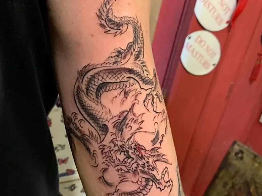 50 Animal Tattoo Ideas: The Complete Guide by Animal, Style and Placement 42 Fine line Japanese dragon tattoo coiling down a forearm