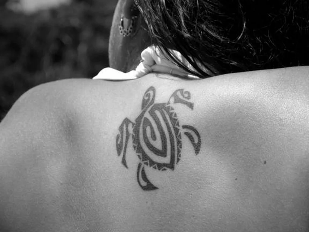 50 Animal Tattoo Ideas: The Complete Guide by Animal, Style and Placement 46 Small tribal sea turtle tattoo on an upper back
