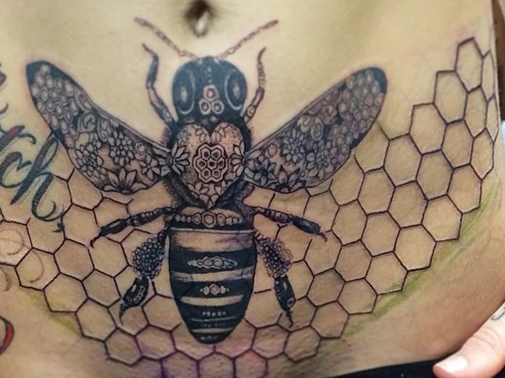 50 Animal Tattoo Ideas: The Complete Guide by Animal, Style and Placement 48 Detailed bee tattoo over a honeycomb pattern across a stomach