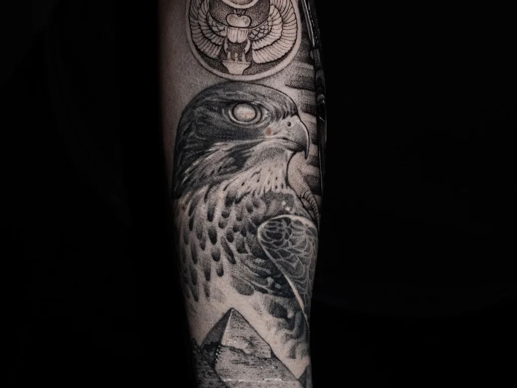 35 Bird Tattoo Ideas: Meanings, Species and Best Placements 17 Hawk tattoo with a crescent moon on a forearm