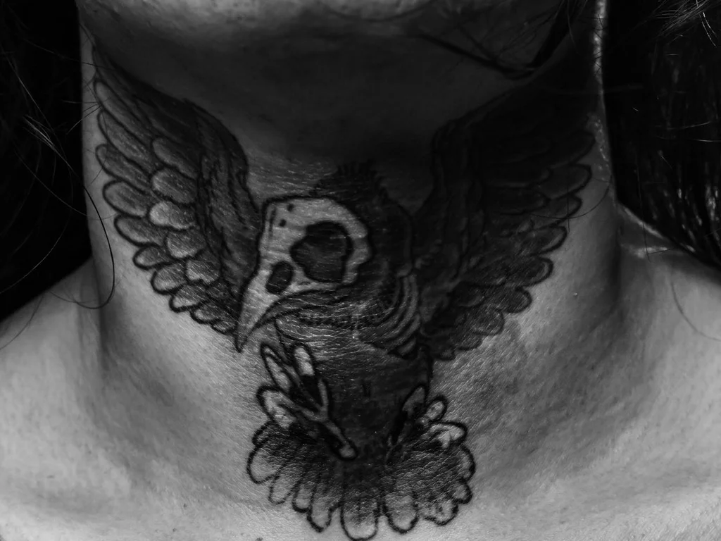 35 Bird Tattoo Ideas: Meanings, Species and Best Placements 26 Owl tattoo with a skull face across the front of a neck