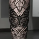 22 Butterfly Tattoo Ideas: Meanings, Styles and Best Placements 26 Ornamental blackwork butterfly tattoo with mandala dotwork covering a calf