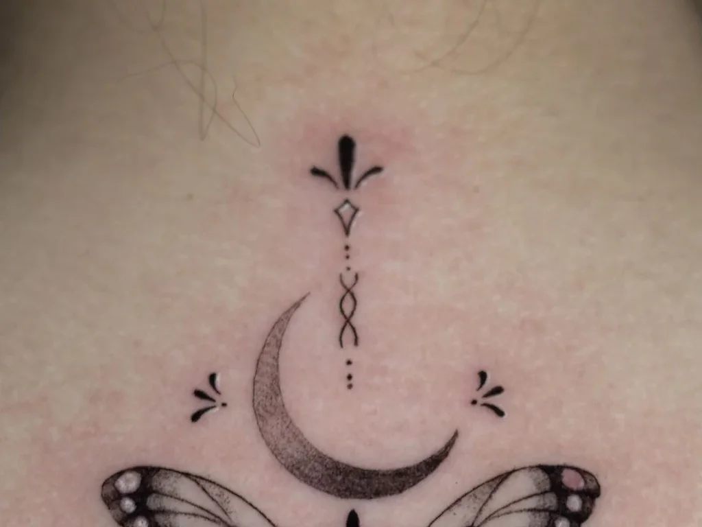 22 Butterfly Tattoo Ideas: Meanings, Styles and Best Placements 11 Dotwork butterfly and crescent moon tattoo on an upper back