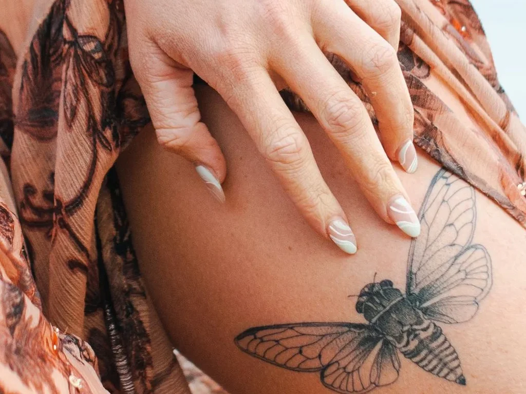 22 Butterfly Tattoo Ideas: Meanings, Styles and Best Placements 12 Delicate fine-line butterfly tattoo on a thigh