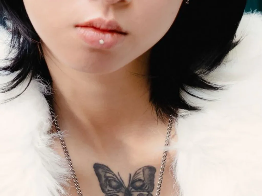 22 Butterfly Tattoo Ideas: Meanings, Styles and Best Placements 13 Small shaded butterfly tattoo in the centre of a chest