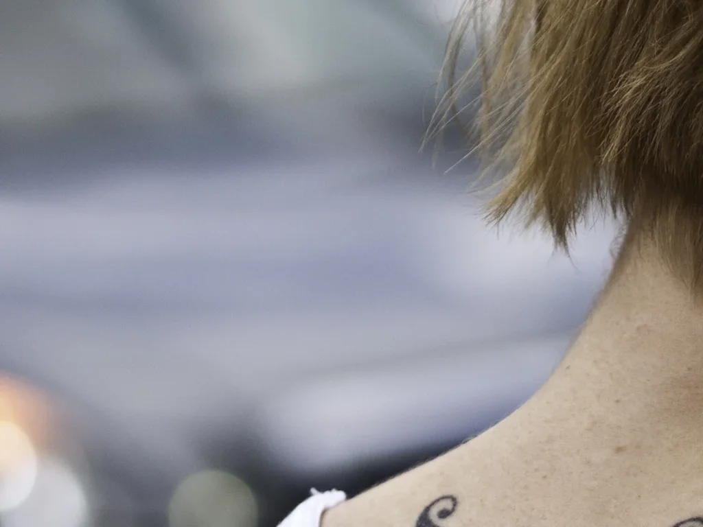 22 Butterfly Tattoo Ideas: Meanings, Styles and Best Placements 16 Purple tribal butterfly tattoo at the nape of the neck