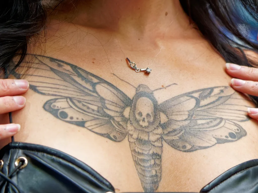 22 Butterfly Tattoo Ideas: Meanings, Styles and Best Placements 20 Death's-head moth tattoo spread across a woman's chest