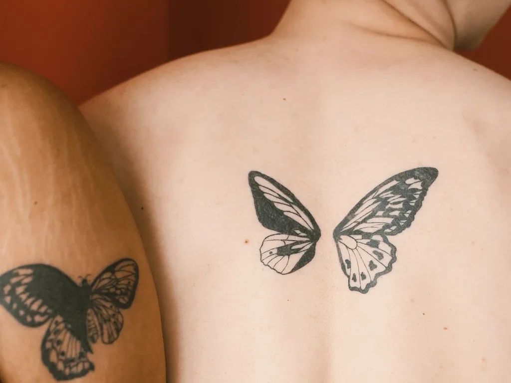 22 Butterfly Tattoo Ideas: Meanings, Styles and Best Placements 22 Matching butterfly tattoos on two people's back and arm