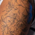 25 Fine Line Tattoo Ideas: Delicate Designs, Honestly Rated 23 Fine line peony bouquet tattoo in black outline on an upper arm