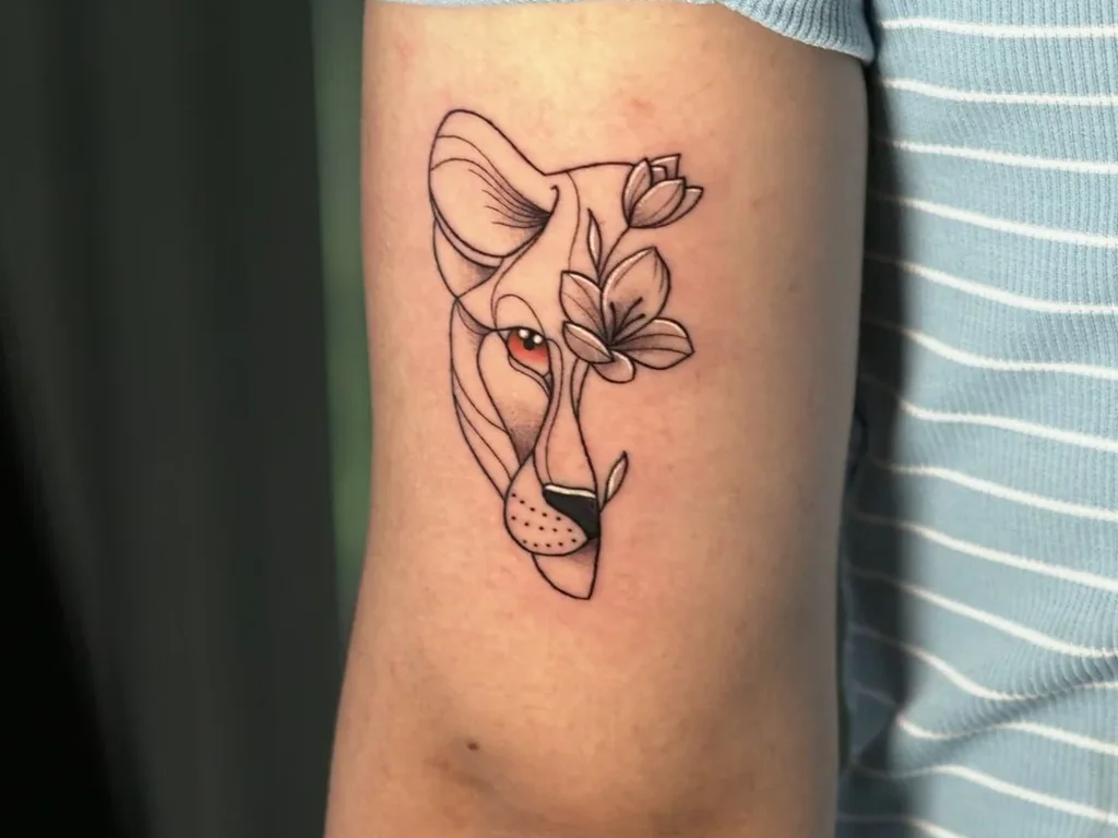 25 Fine Line Tattoo Ideas: Delicate Designs, Honestly Rated 11 Fine line lioness face tattoo split with flowers on an upper arm