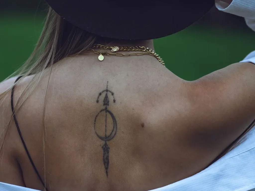25 Fine Line Tattoo Ideas: Delicate Designs, Honestly Rated 26 Ornamental fine line tattoo with circles and a hanging drop running down a spine