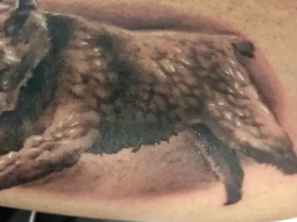22 Pet Tattoo Ideas: Portraits, Paw Prints and Memorials Done Right 5 Black and grey tattoo of a shaggy coated dog mid stride on a forearm