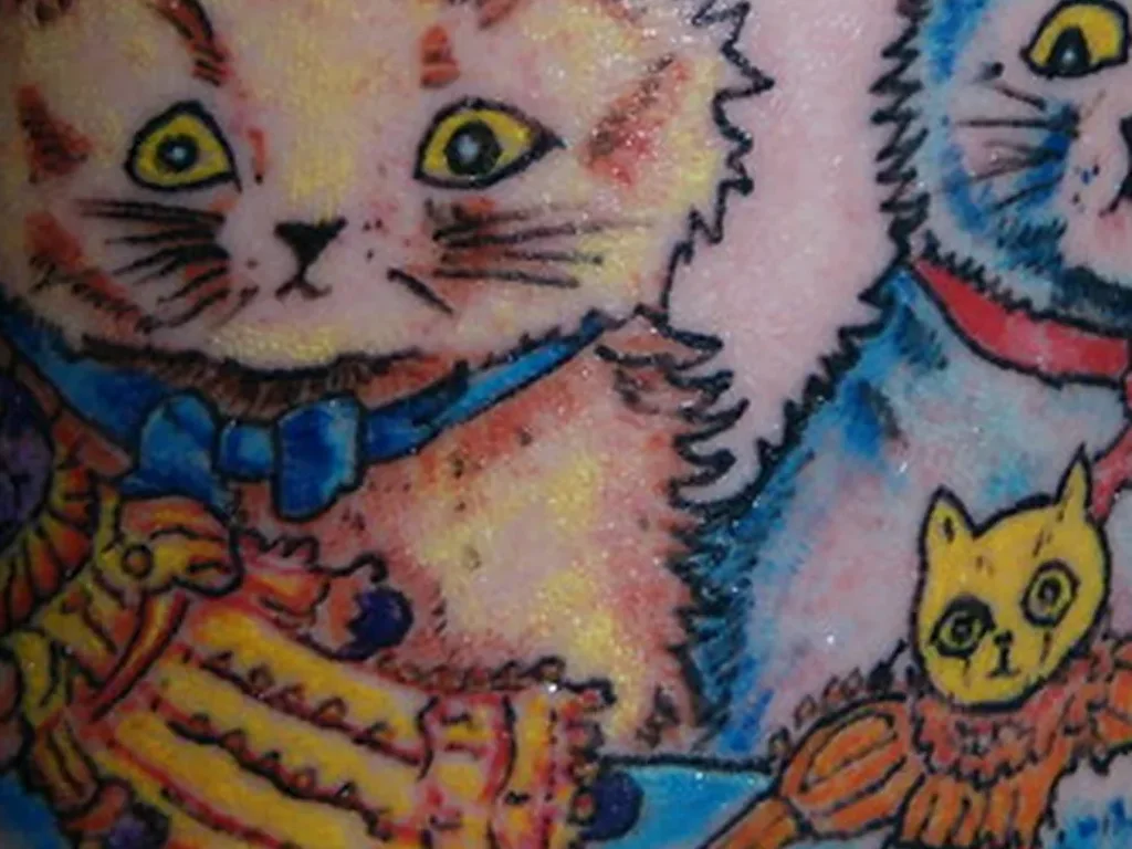 22 Pet Tattoo Ideas: Portraits, Paw Prints and Memorials Done Right 14 Colour tattoo of two vintage storybook style kittens on a leg