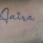 Name tattooed in fine cursive script across the inner wrist