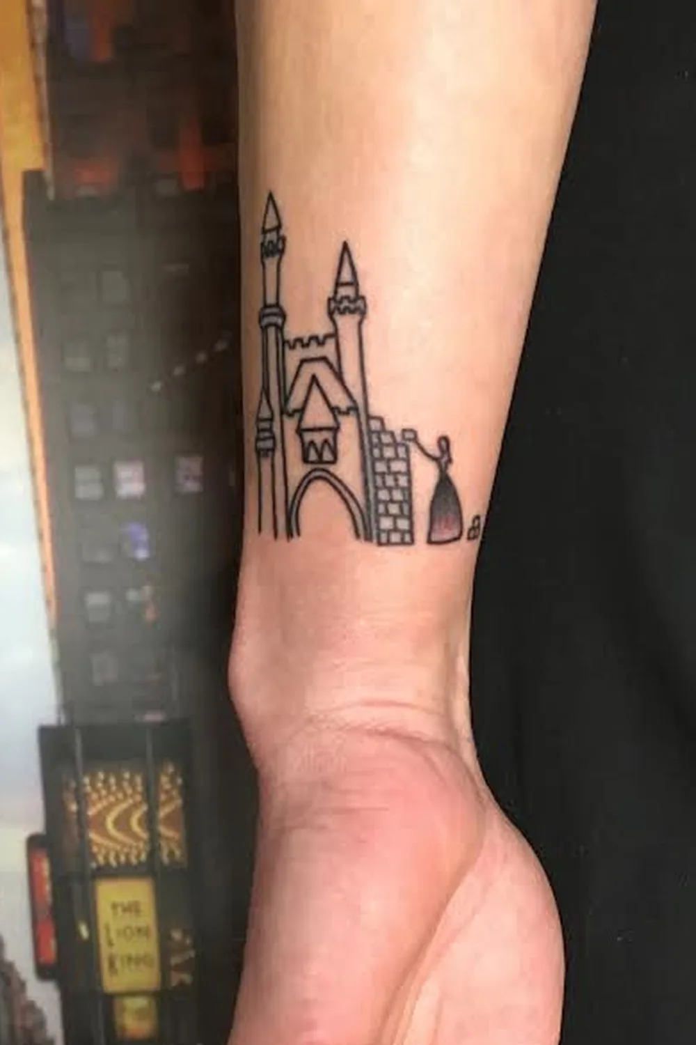 23 Small Tattoos for Women: Tiny Designs That Say a Lot, Quietly 3 Tiny line-work castle tattoo with a small princess figure on the inner wrist
