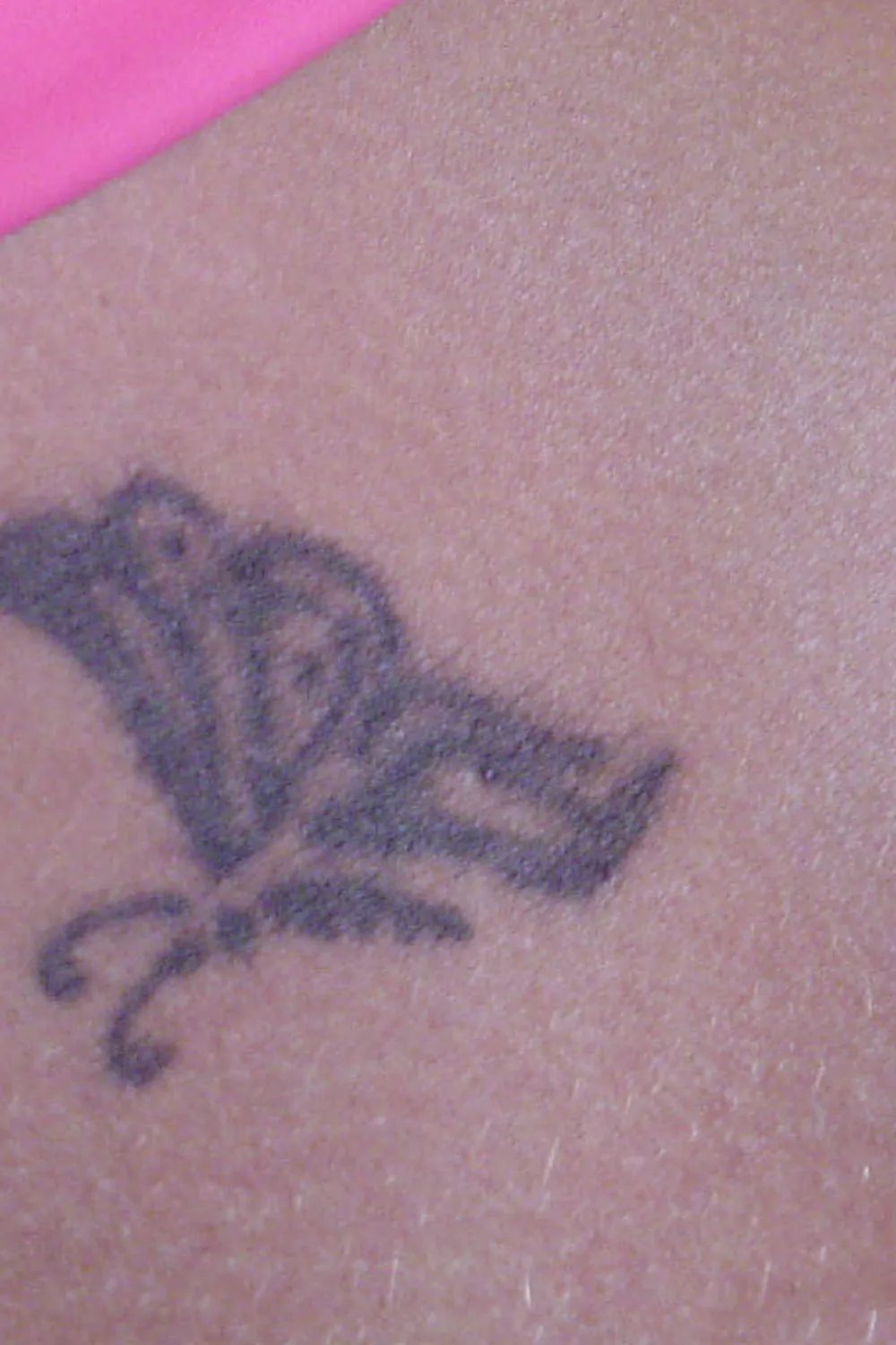 23 Small Tattoos for Women: Tiny Designs That Say a Lot, Quietly 7 Small dark butterfly tattoo low on the hip