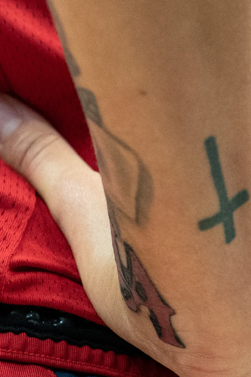 23 Small Tattoos for Women: Tiny Designs That Say a Lot, Quietly 15 Tiny black cross tattoo on the forearm