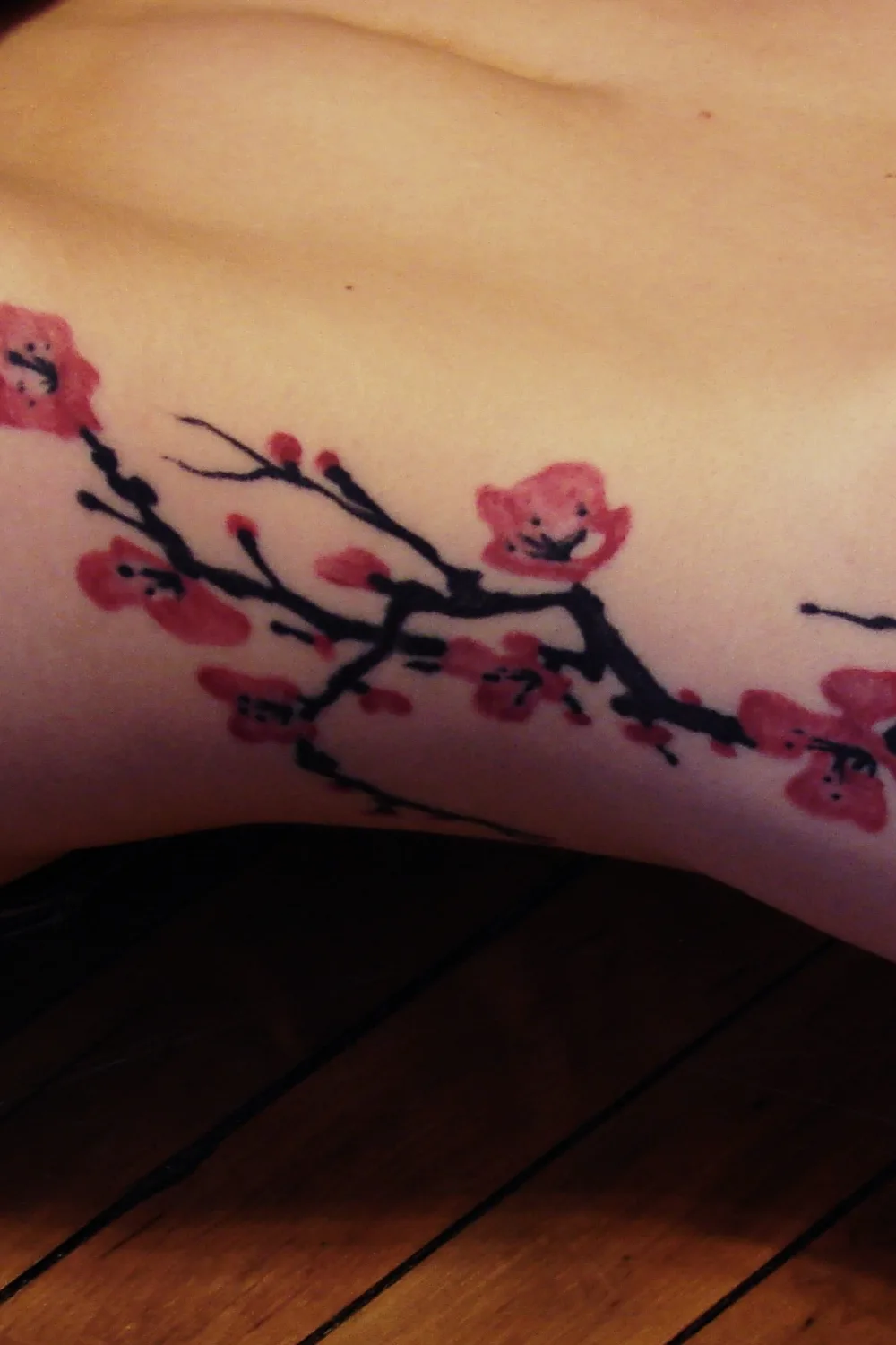 23 Small Tattoos for Women: Tiny Designs That Say a Lot, Quietly 19 Cherry blossom branch tattoo along the ribs