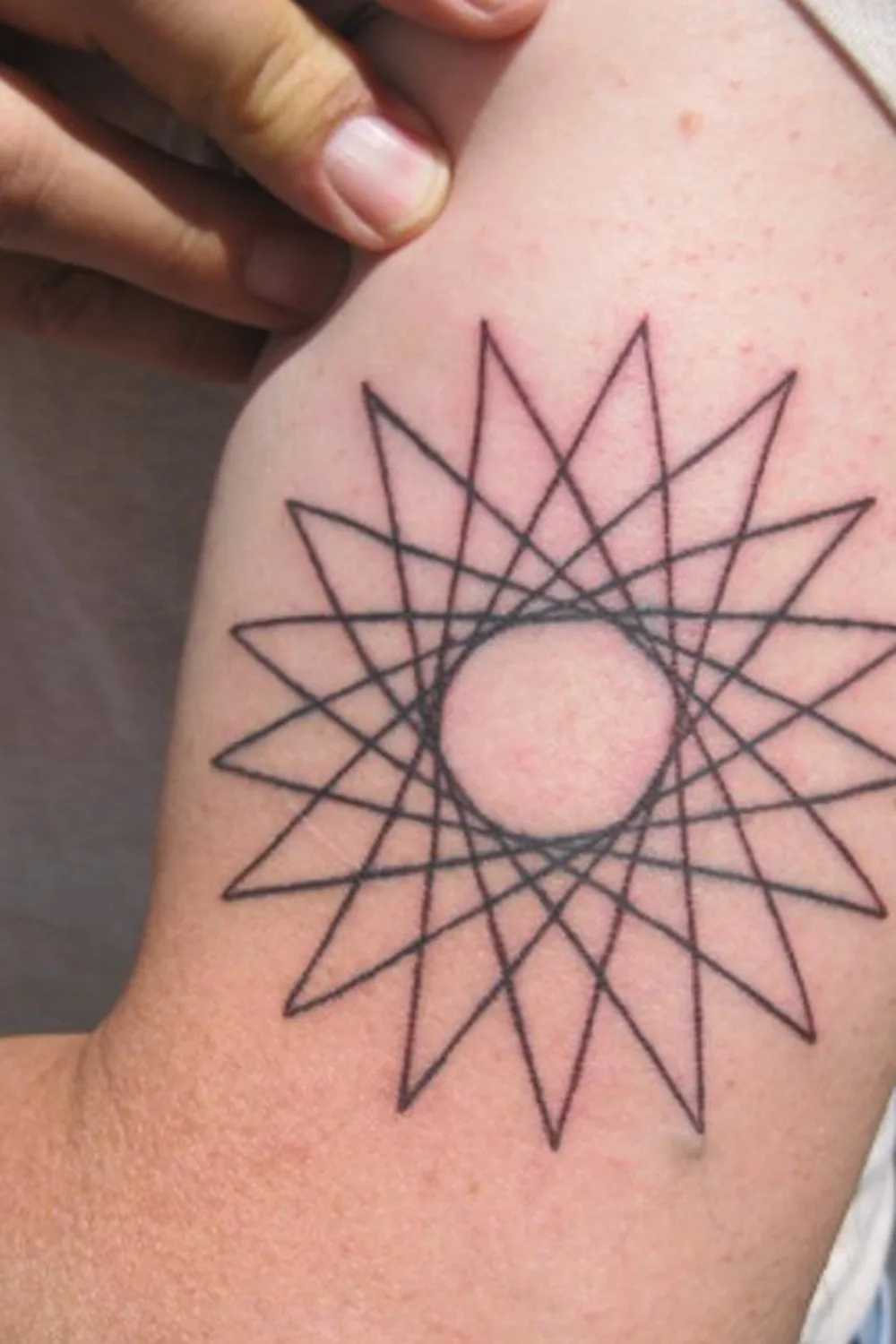 23 Small Tattoos for Women: Tiny Designs That Say a Lot, Quietly 21 Fine line seventeen-point star tattoo on the upper arm