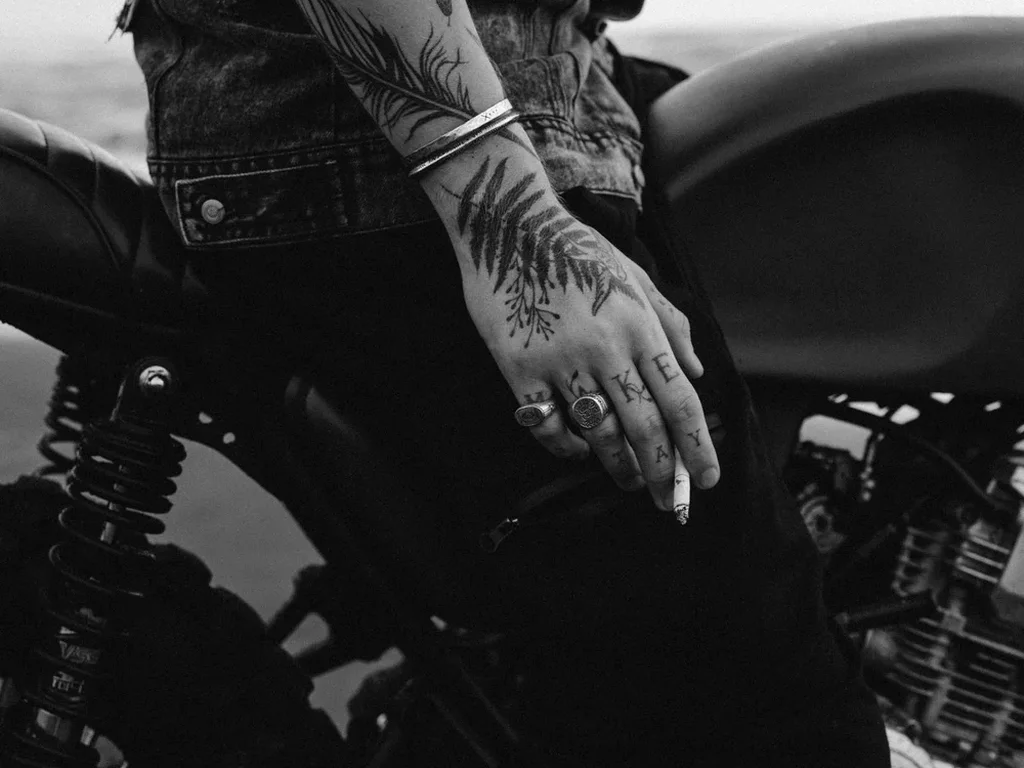 20 Snake Tattoo Ideas: Meanings, Styles and Placements That Work 16 Coiled snake tattoo on a forearm in black and white, rider portrait