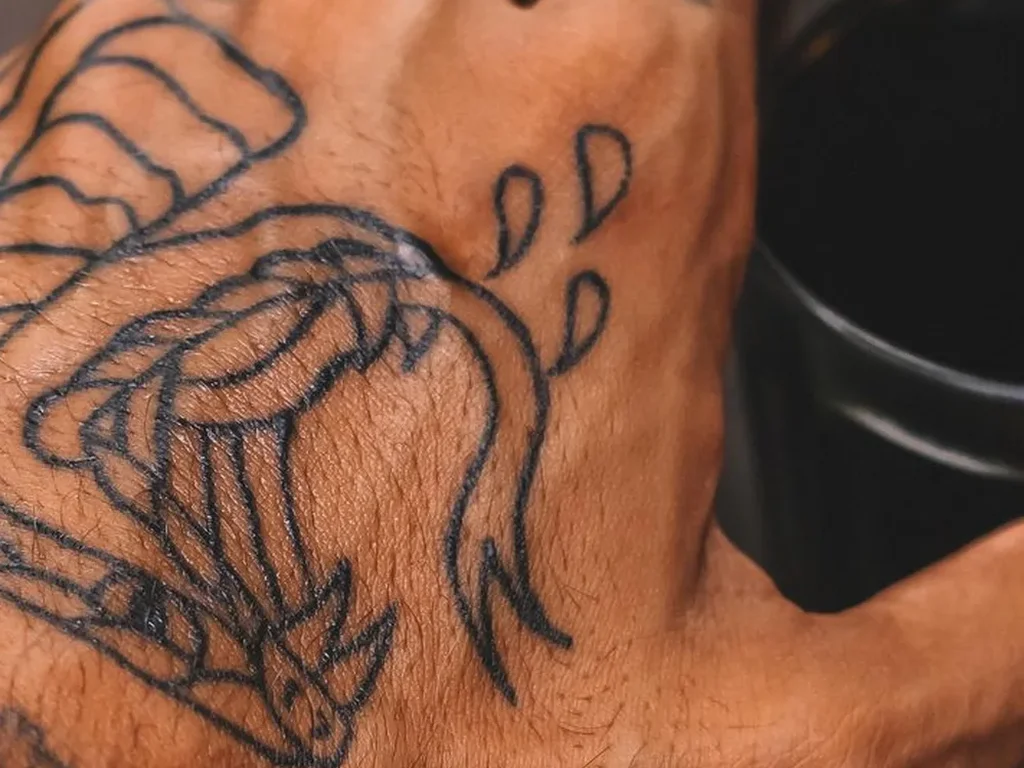 20 Snake Tattoo Ideas: Meanings, Styles and Placements That Work 17 Line work snake head tattoo striking across the back of a hand