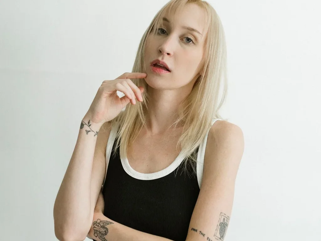 20 Snake Tattoo Ideas: Meanings, Styles and Placements That Work 19 Small simple black snake tattoo on a woman's forearm